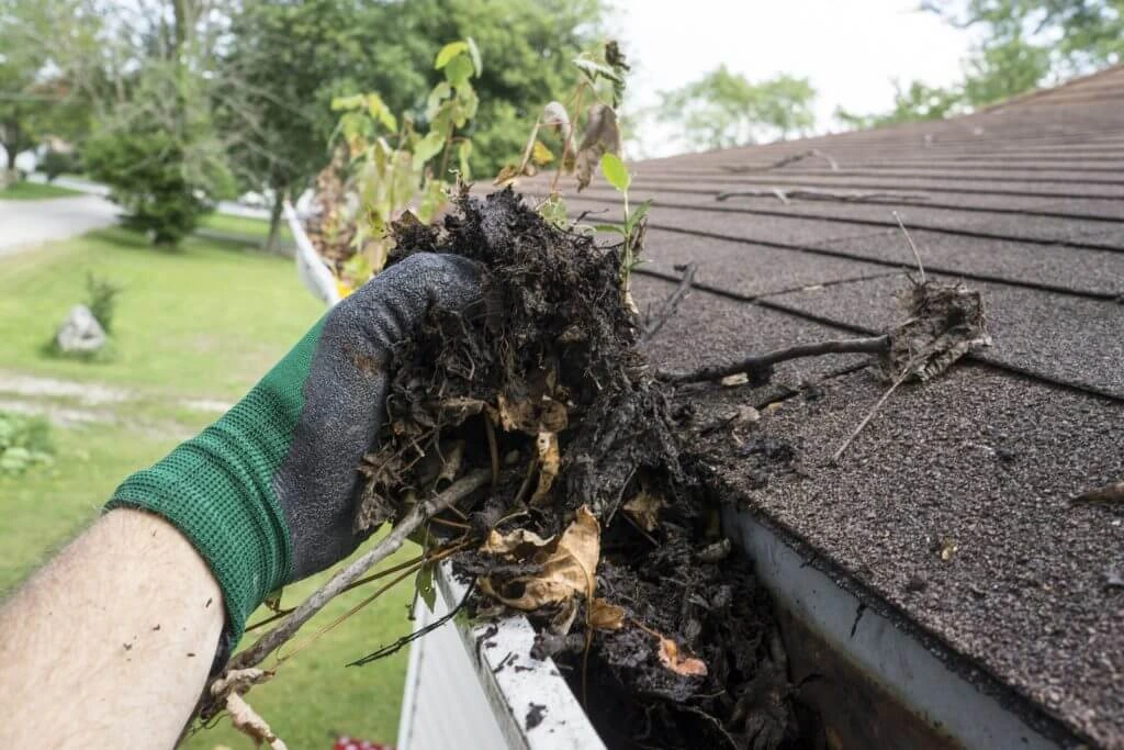 bigstock Worker Cleaning Gutters